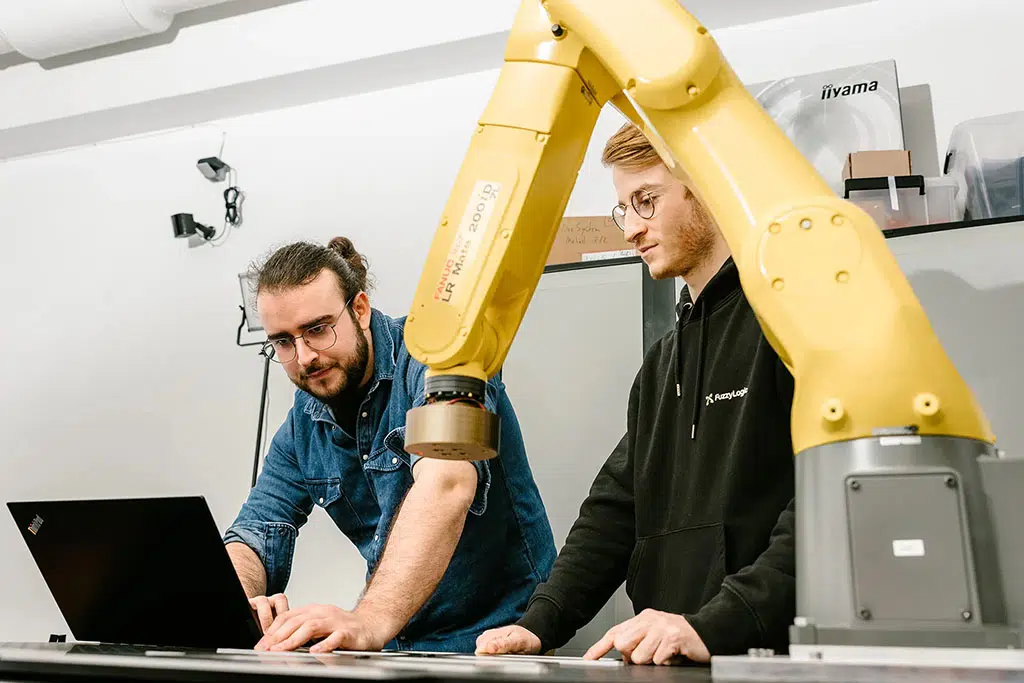 Corporate Photography Feature in Paris — Engineers Programming Industrial Robotic Arms at Fuzzy Logic, Tech Corporate Photography — Guillaume Galmiche